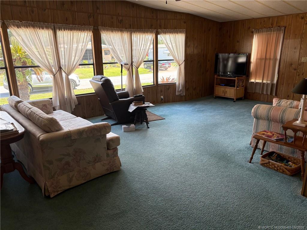 2856 Southwest Toronado Trail Stuart, FL 34997 - Photo 7 of 20 a living room with furniture and a flat screen tv