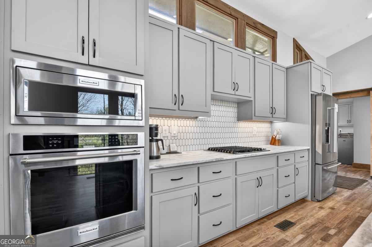 466 Watersong Bluff West Ellijay, GA 30540 - Photo 19 of 67 a kitchen with cabinets stainless steel appliances and sink