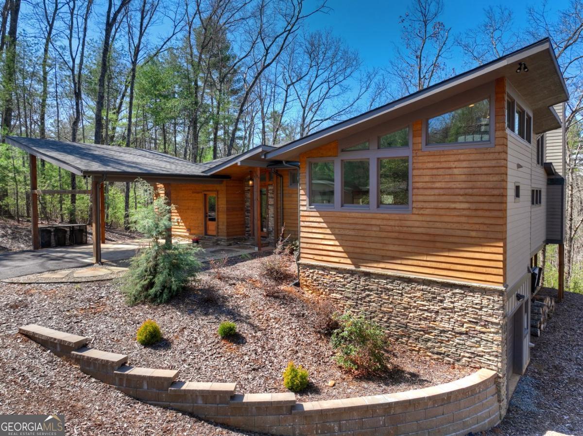 466 Watersong Bluff West Ellijay, GA 30540 - Photo 2 of 67 a view of a backyard with plants and large tree