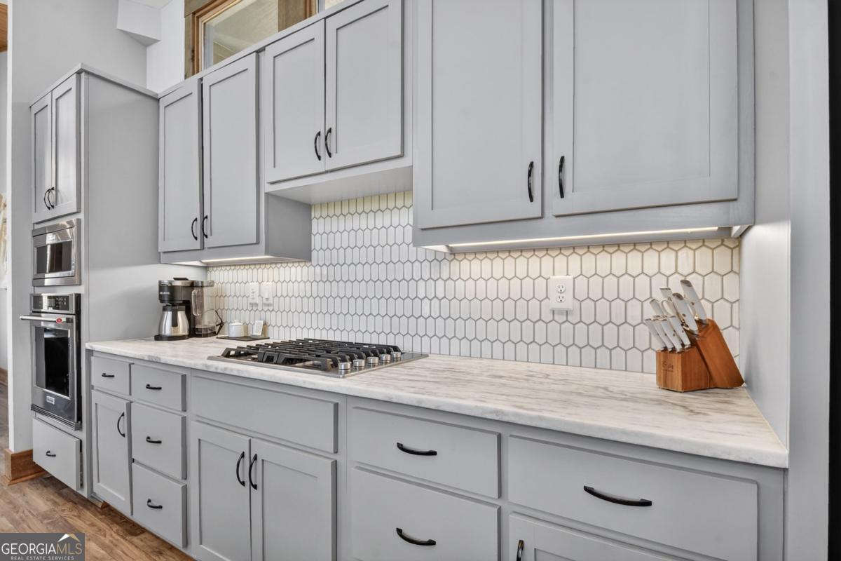 466 Watersong Bluff West Ellijay, GA 30540 - Photo 24 of 67 a kitchen with white cabinets and sink