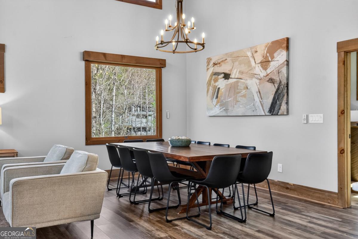 466 Watersong Bluff West Ellijay, GA 30540 - Photo 28 of 67 a view of a dining room with furniture wooden floor and a chandelier