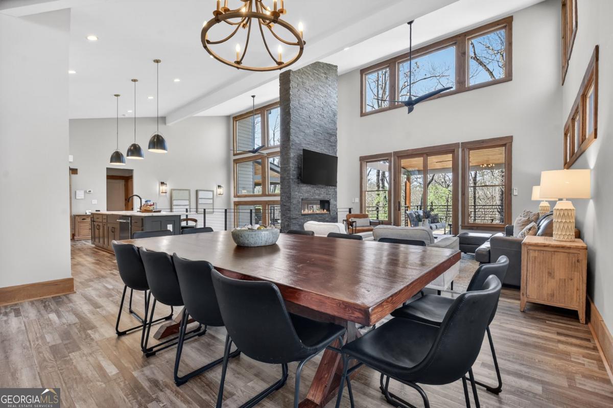 466 Watersong Bluff West Ellijay, GA 30540 - Photo 29 of 67 a dining room with stainless steel appliances kitchen island a table and chairs in it