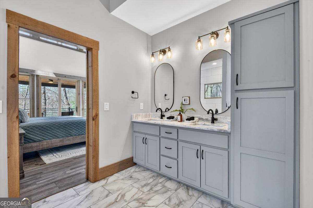 466 Watersong Bluff West Ellijay, GA 30540 - Photo 34 of 67 a en suite bathroom with double vanity a sink and mirrors