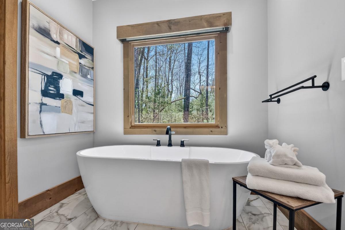 466 Watersong Bluff West Ellijay, GA 30540 - Photo 36 of 67 a white bath tub sitting in a bathroom next to a window