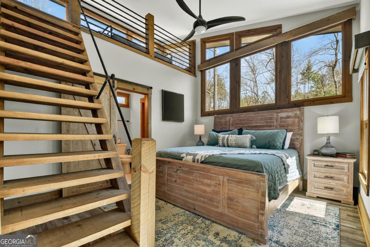 466 Watersong Bluff West Ellijay, GA 30540 - Photo 37 of 67 a bed sitting in a bedroom next to a window