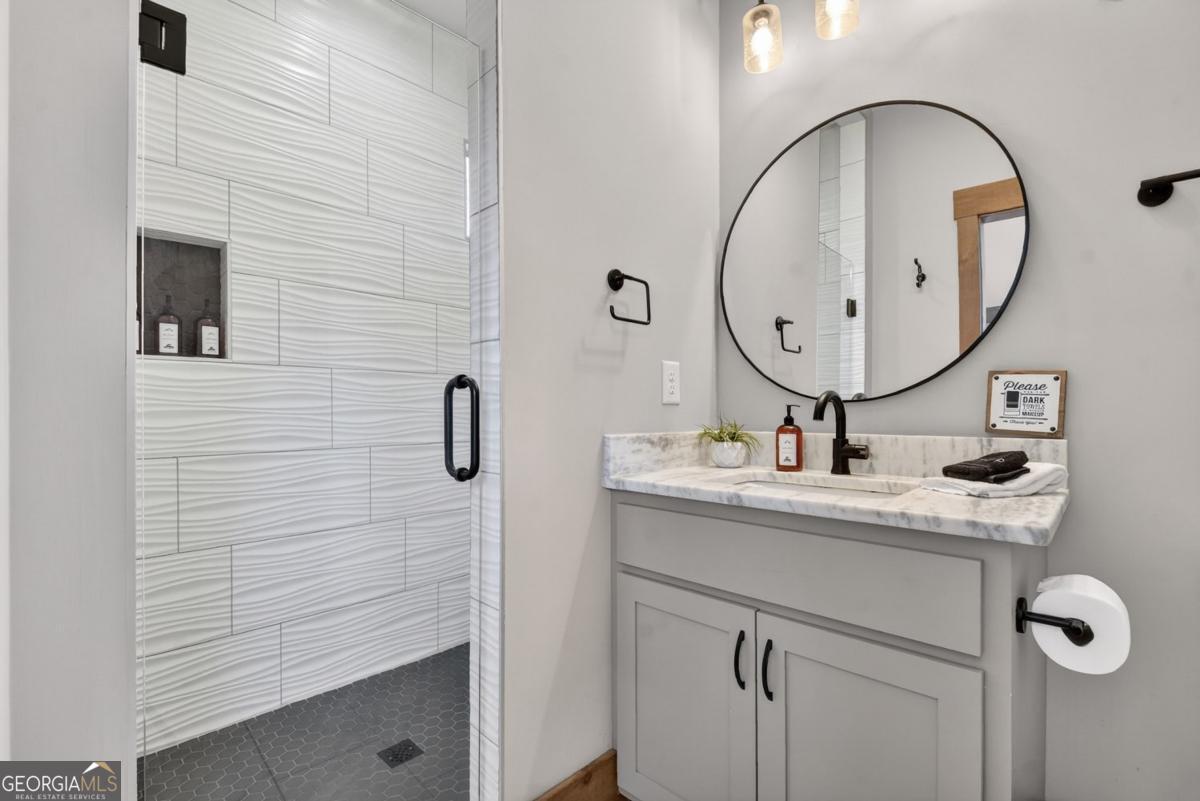 466 Watersong Bluff West Ellijay, GA 30540 - Photo 40 of 67 a bathroom with a sink and a mirror