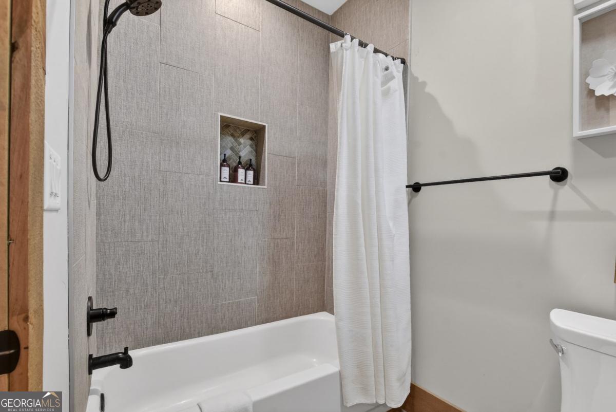 466 Watersong Bluff West Ellijay, GA 30540 - Photo 55 of 67 a bathroom with a shower and a tub