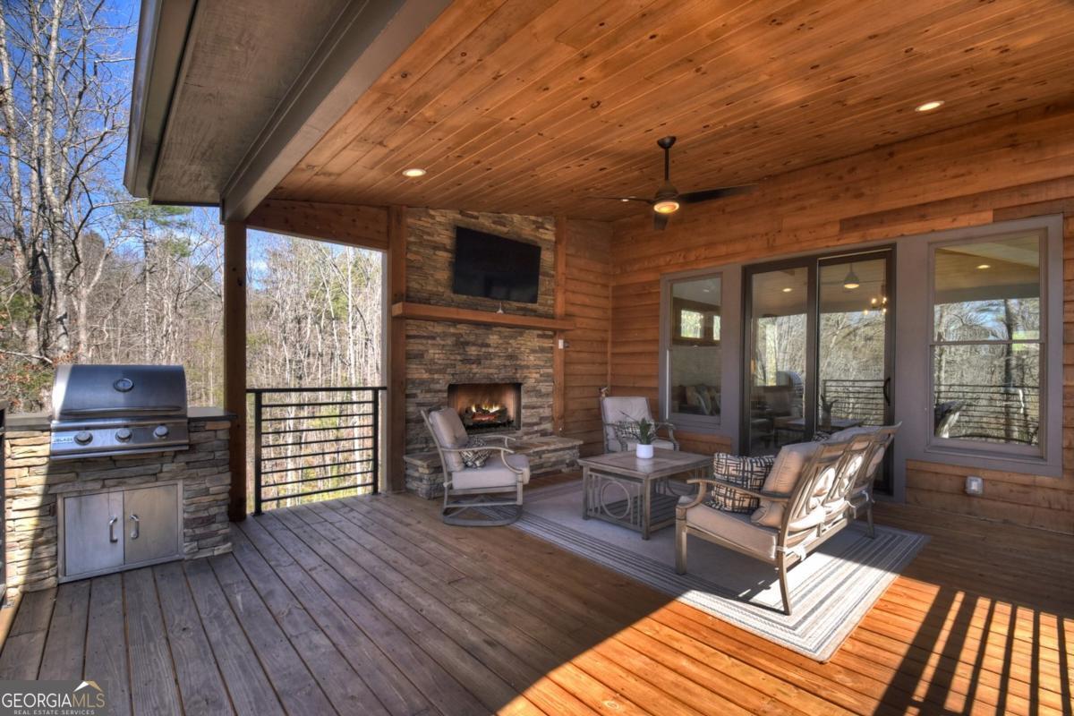 466 Watersong Bluff West Ellijay, GA 30540 - Photo 59 of 67 a living room with furniture a fireplace and a flat screen tv