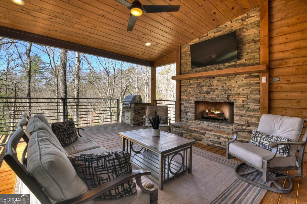 466 Watersong Bluff West Ellijay, GA 30540 - Photo 61 of 67 a living room with furniture a flat screen tv and a fireplace