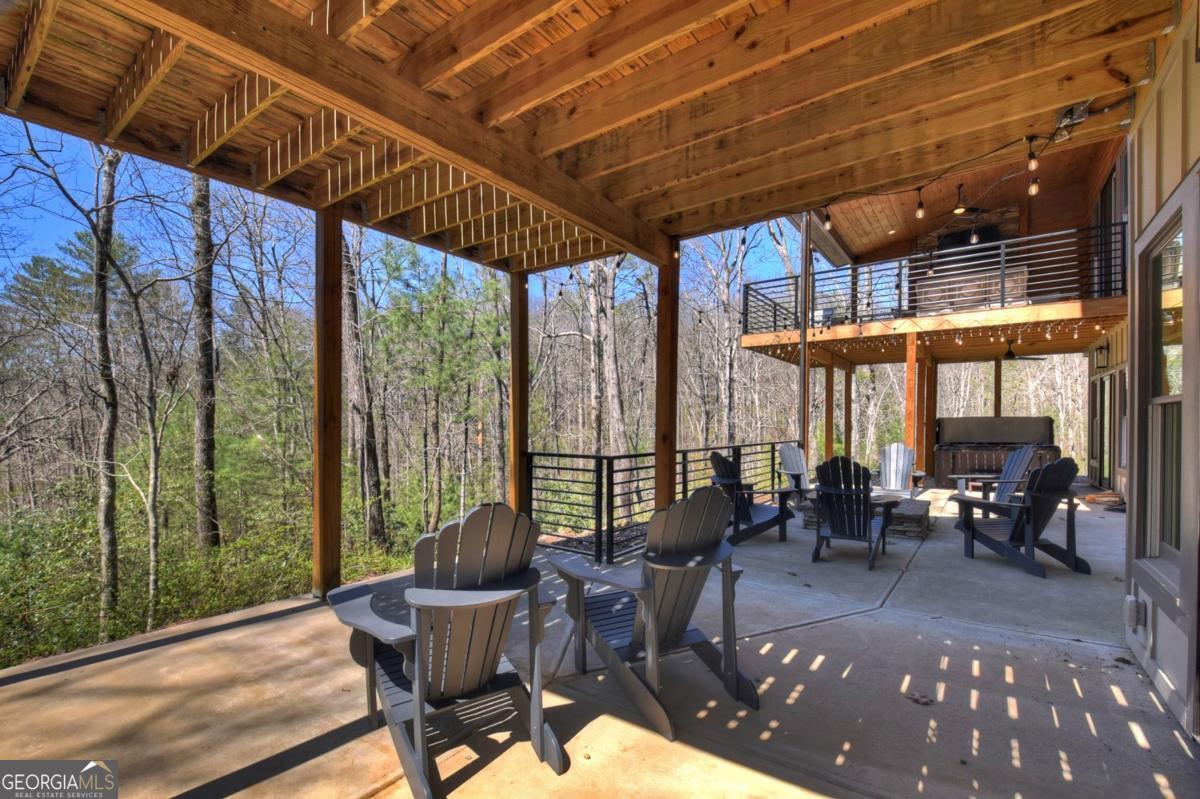 466 Watersong Bluff West Ellijay, GA 30540 - Photo 64 of 67 a view of a porch with chairs and backyard
