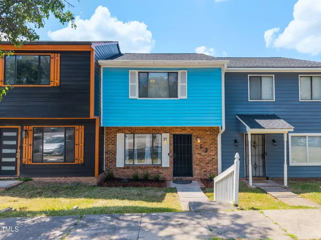 a view of a house with swimming pool and sitting area