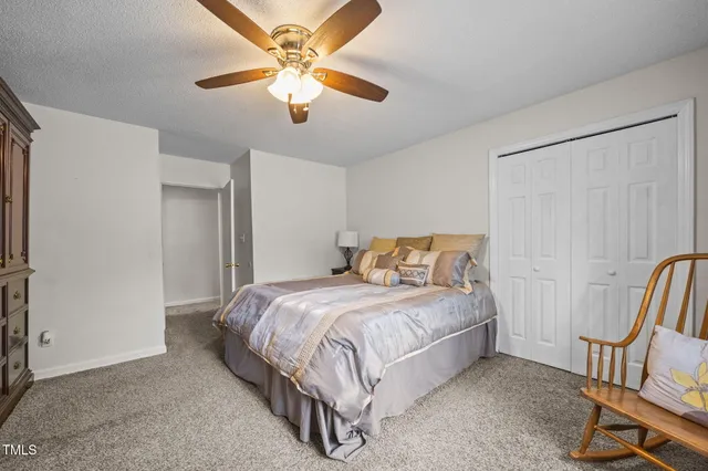 a bedroom with a bed chairs and a chandelier