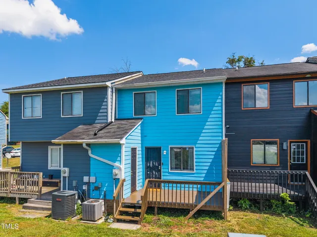 a view of a house with a patio and a yard