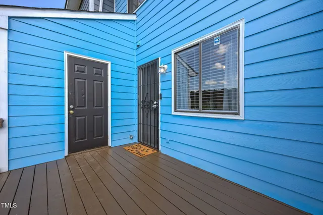 a view of front door deck house with wooden floor