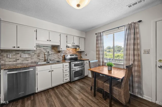 a kitchen with a sink cabinets and window