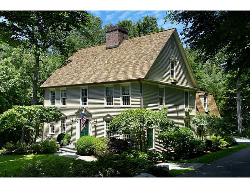 a front view of house with a garden