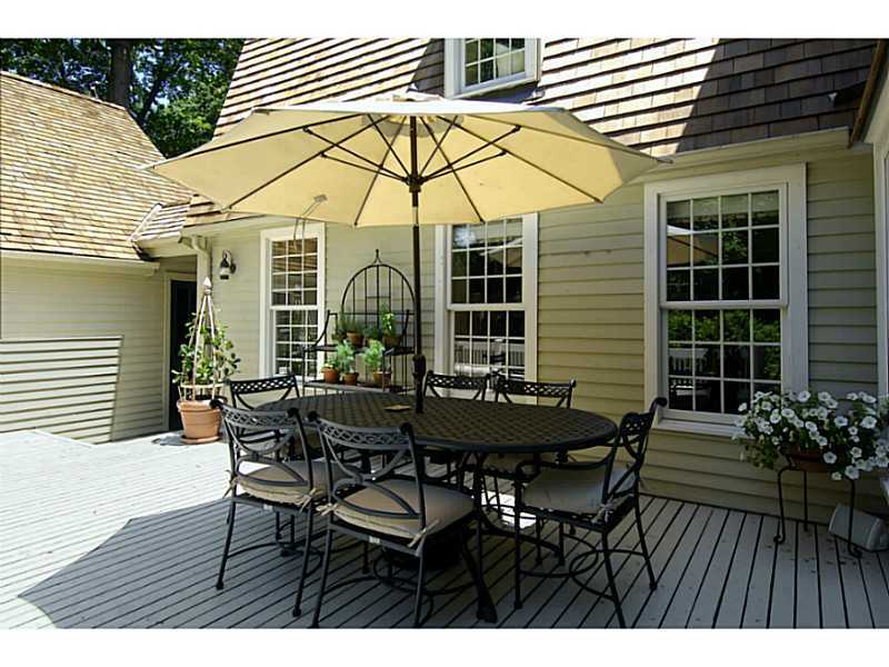 104 Old Stone Bridge Road Cos Cob, CT 06807 - Photo 11 of 12 a view of a dining table and chairs in the patio