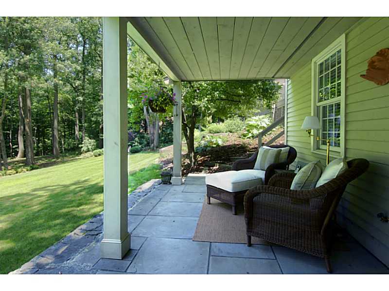 104 Old Stone Bridge Road Cos Cob, CT 06807 - Photo 12 of 12 a view of a patio with couches potted plants and a big yard