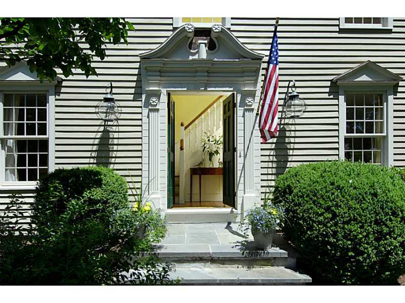 104 Old Stone Bridge Road Cos Cob, CT 06807 - Photo 2 of 12 a front view of a house with a garden
