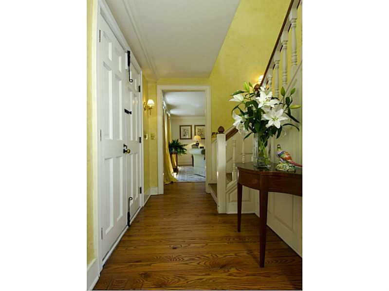 104 Old Stone Bridge Road Cos Cob, CT 06807 - Photo 3 of 12 a hallway with wooden floor and a potted plant