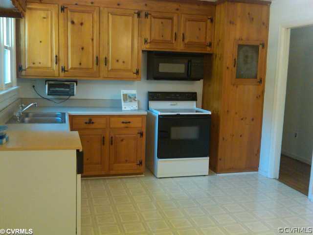 21500 Genito Road Moseley, VA 23120 - Photo 3 of 11 a kitchen with stainless steel appliances granite countertop a stove a microwave and a refrigerator