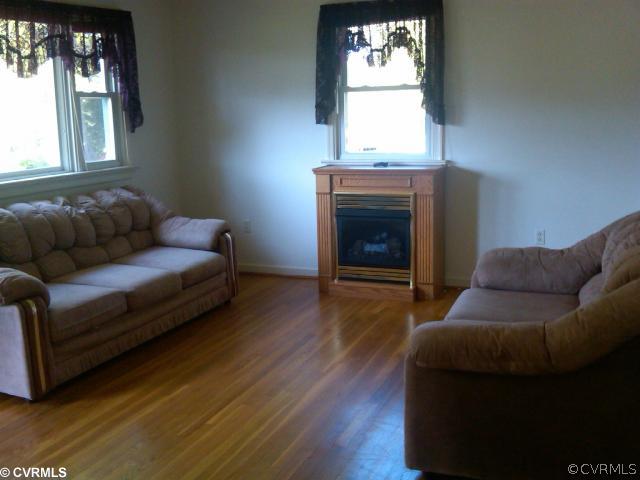 21500 Genito Road Moseley, VA 23120 - Photo 4 of 11 a living room with furniture and a fireplace