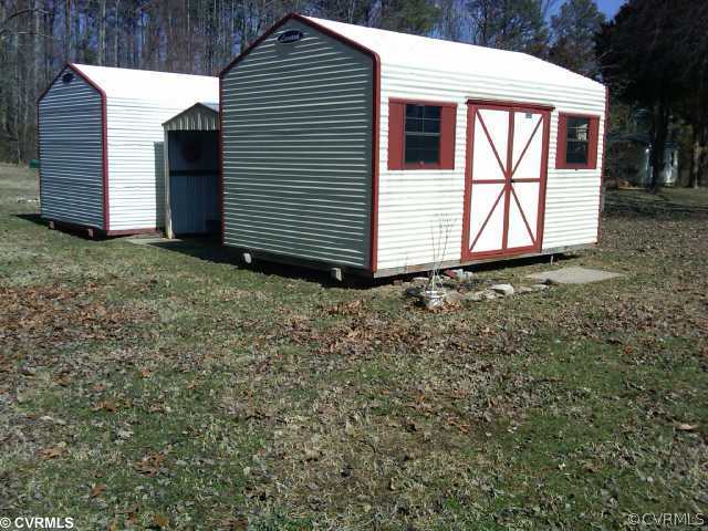 21500 Genito Road Moseley, VA 23120 - Photo 8 of 11 a view of a house with a yard and garage