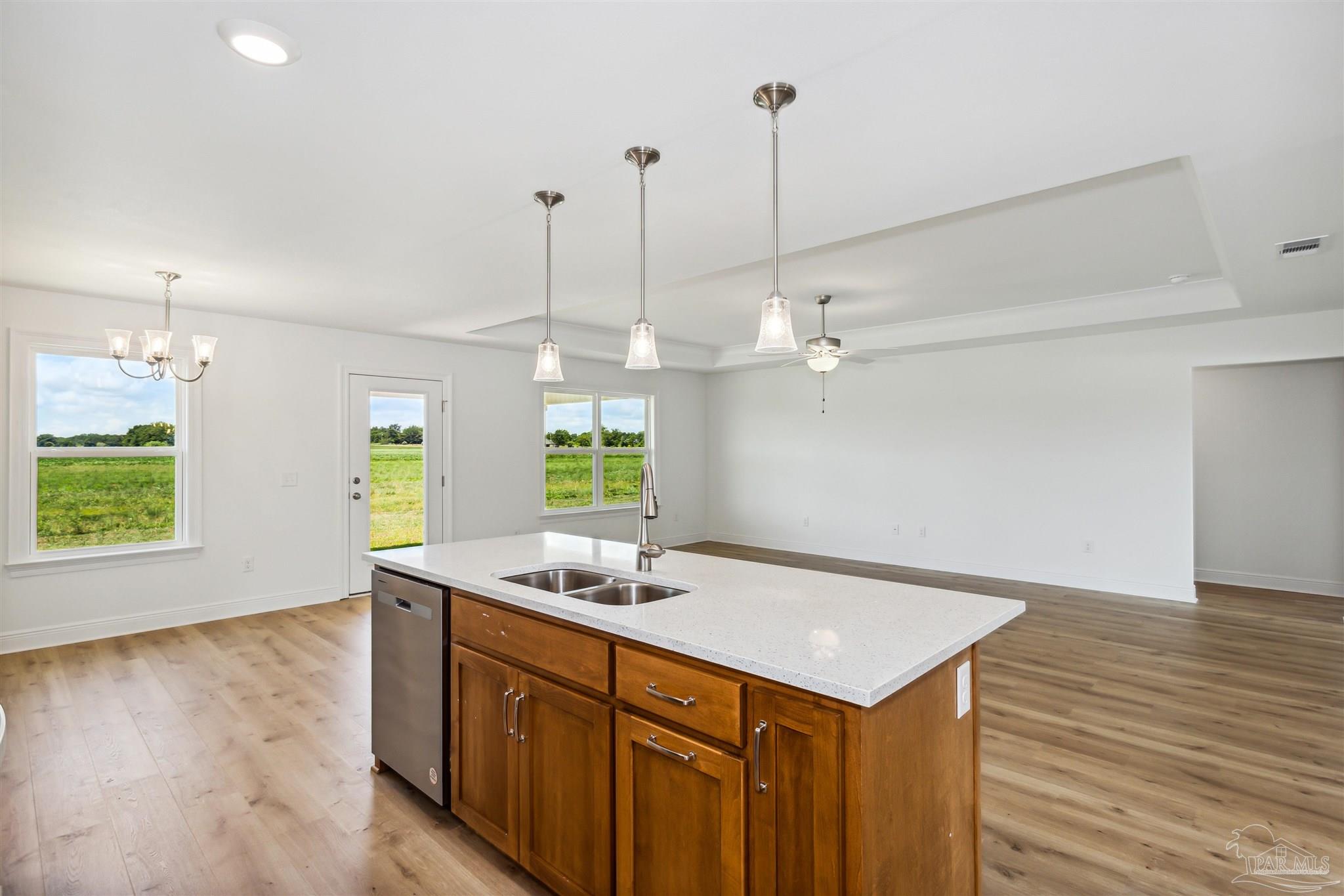 9319 Salter Road Pace, FL 32571 - Photo 13 of 32 a kitchen with a sink chandelier and wooden floor