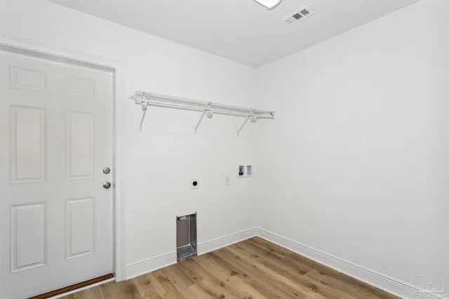 a view of a room with wooden floor