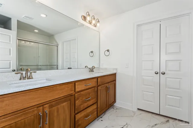 a bathroom with double sink and a mirror