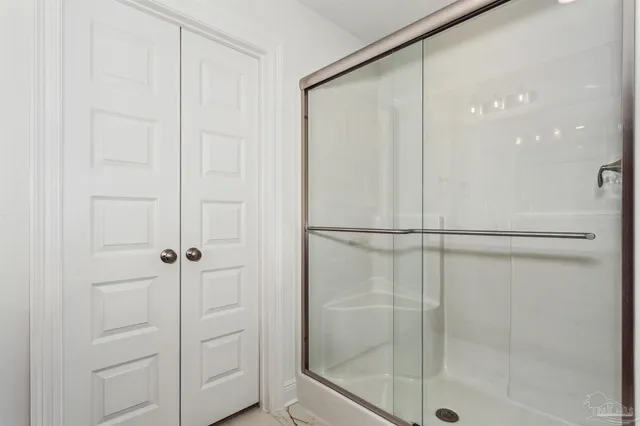 a bathroom with a glass shower door