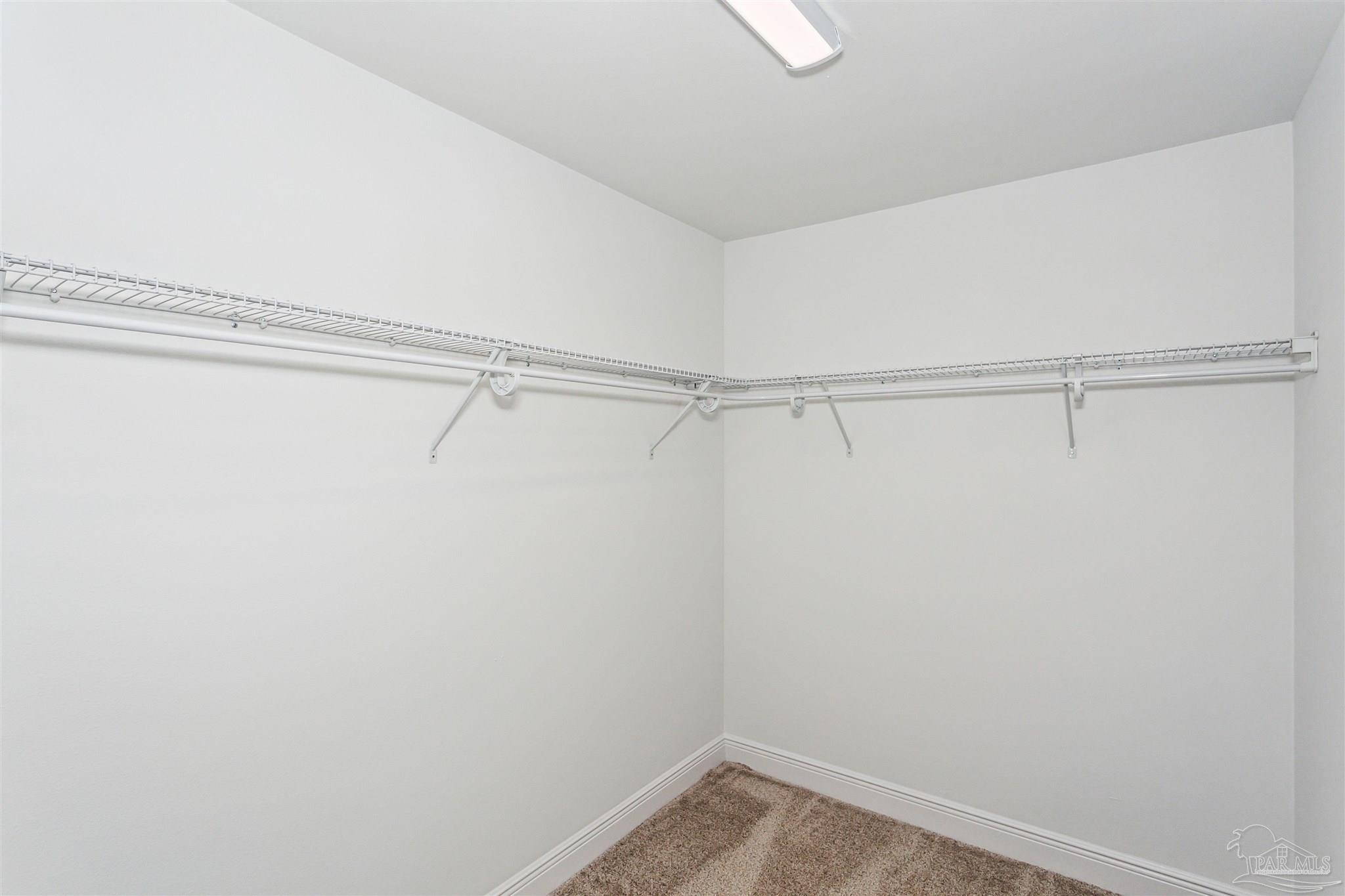9319 Salter Road Pace, FL 32571 - Photo 27 of 32 a view of a room with racks on the wall