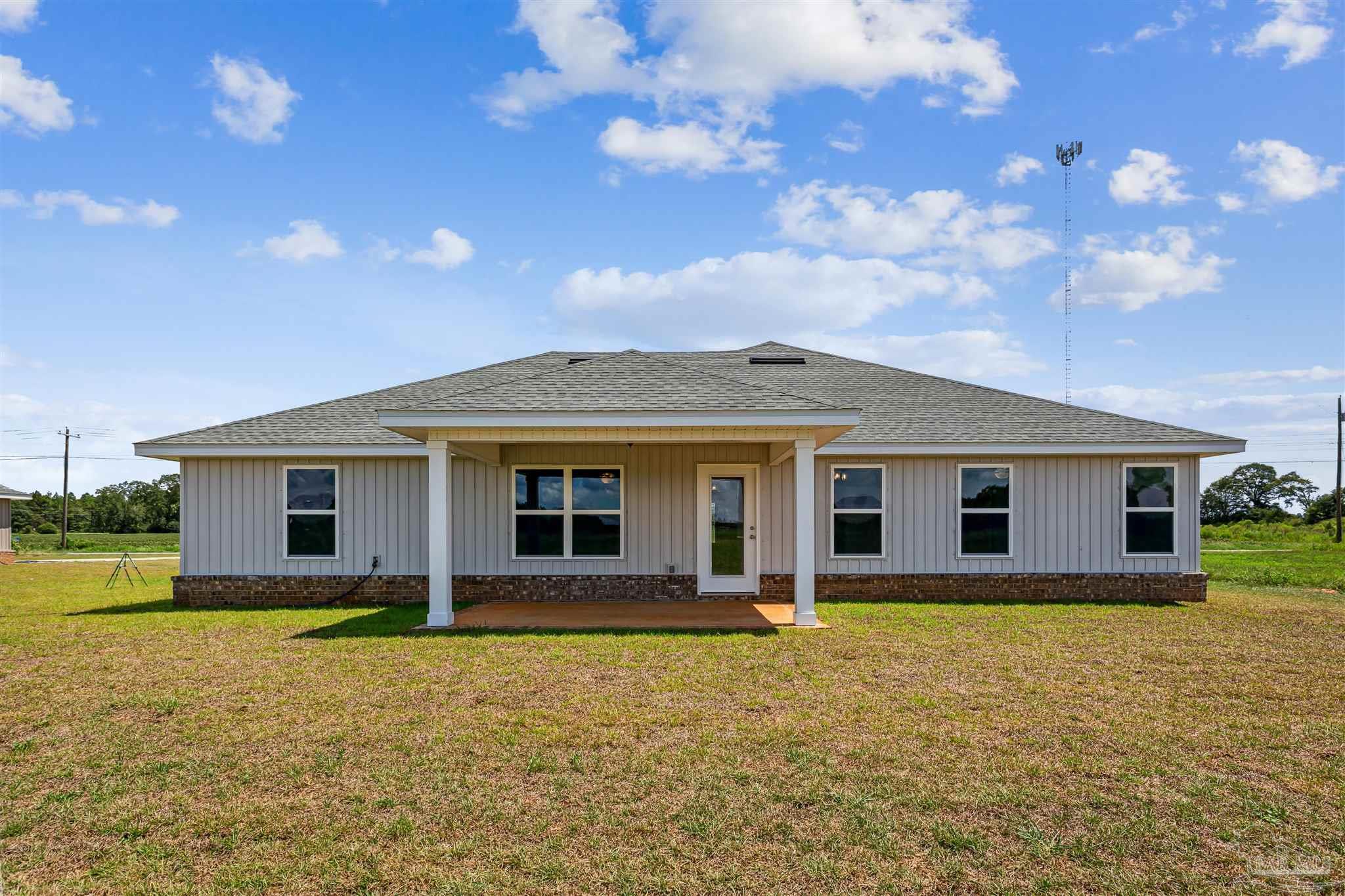 9319 Salter Road Pace, FL 32571 - Photo 31 of 32 a front view of house with yard and trees in the background