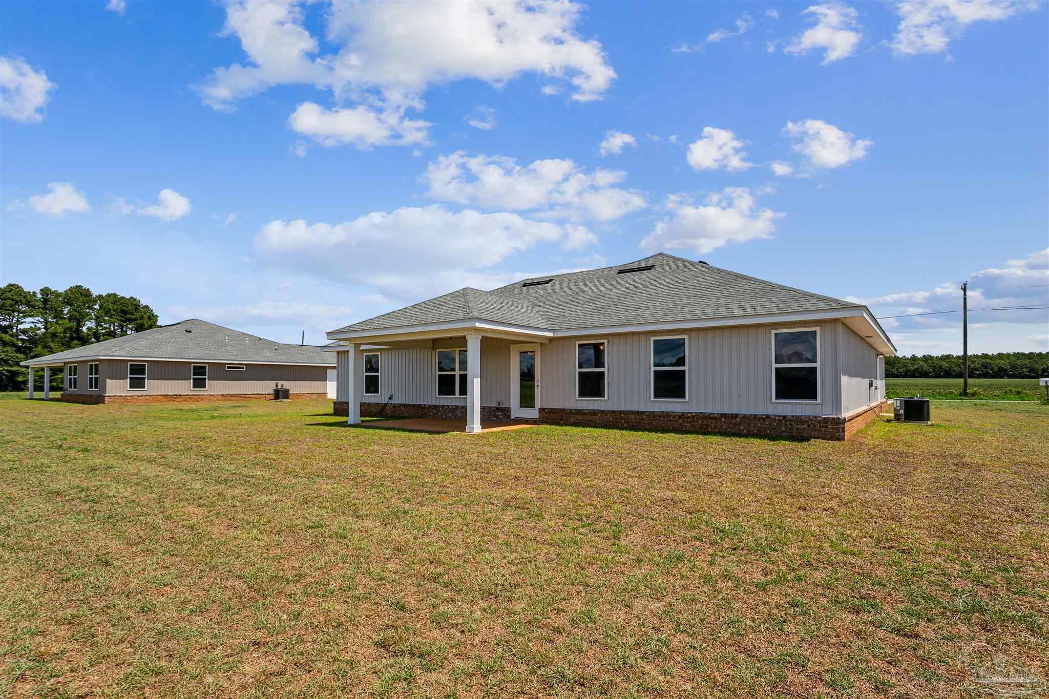 9319 Salter Road Pace, FL 32571 - Photo 32 of 32 a front view of a house with garden