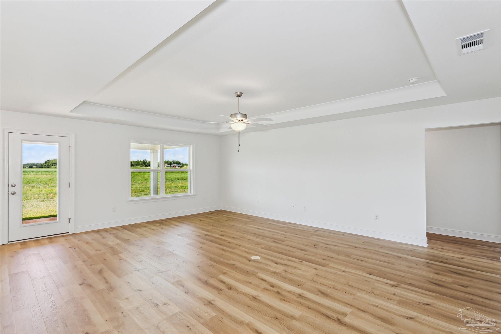 9319 Salter Road Pace, FL 32571 - Photo 5 of 32 an empty room with wooden floor and windows