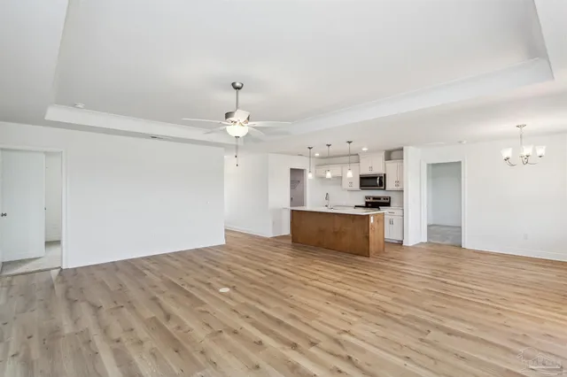 a view of kitchen with granite countertop cabinets and refrigerator
