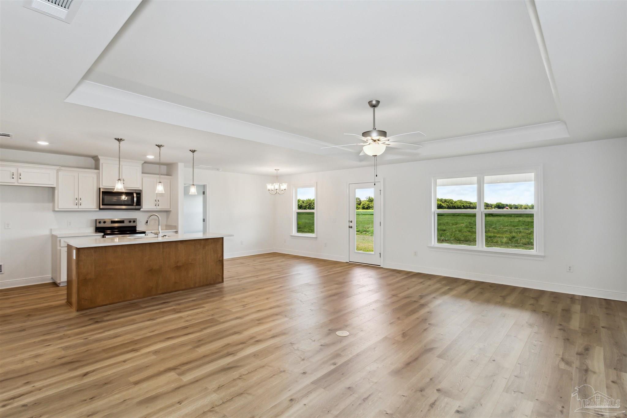 9319 Salter Road Pace, FL 32571 - Photo 7 of 32 a view of kitchen with sink a refrigerator and a large window