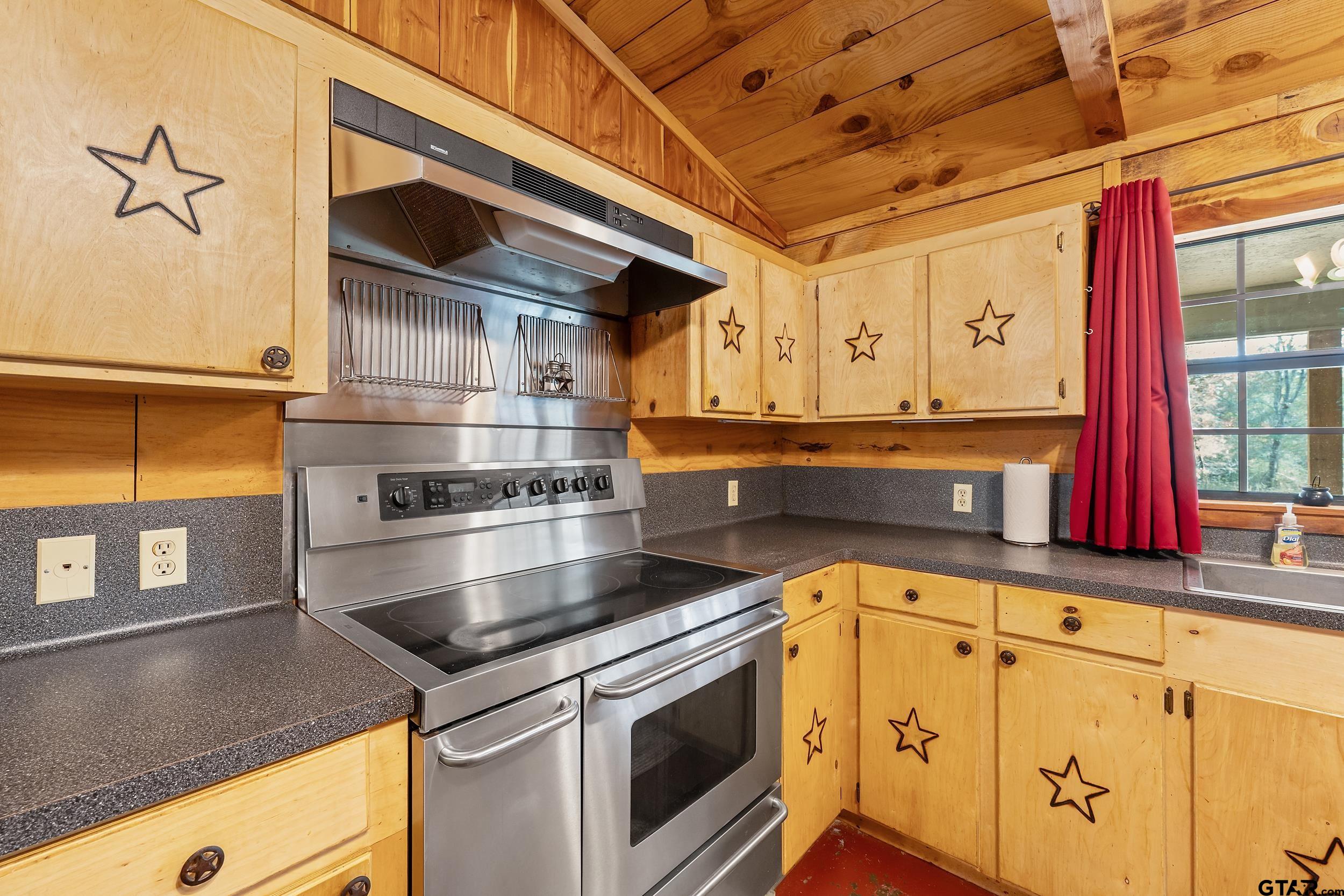 20304 State Highway 155 Winona, TX 75792 - Photo 28 of 48 a utility room with stainless steel appliances granite countertop a sink a stove and cabinets