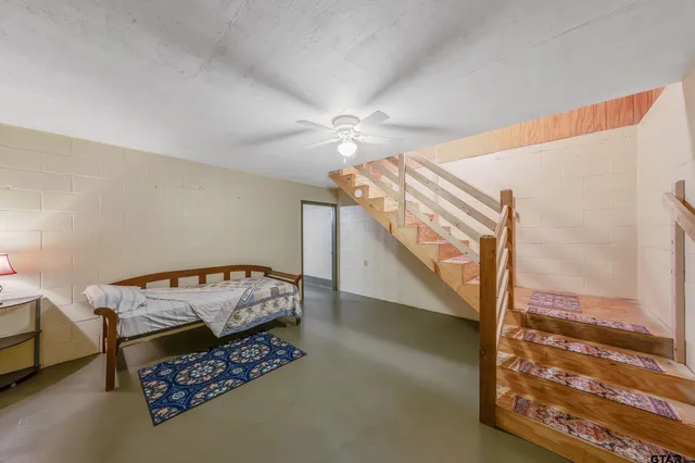 a bedroom with two beds and lamp chandelier