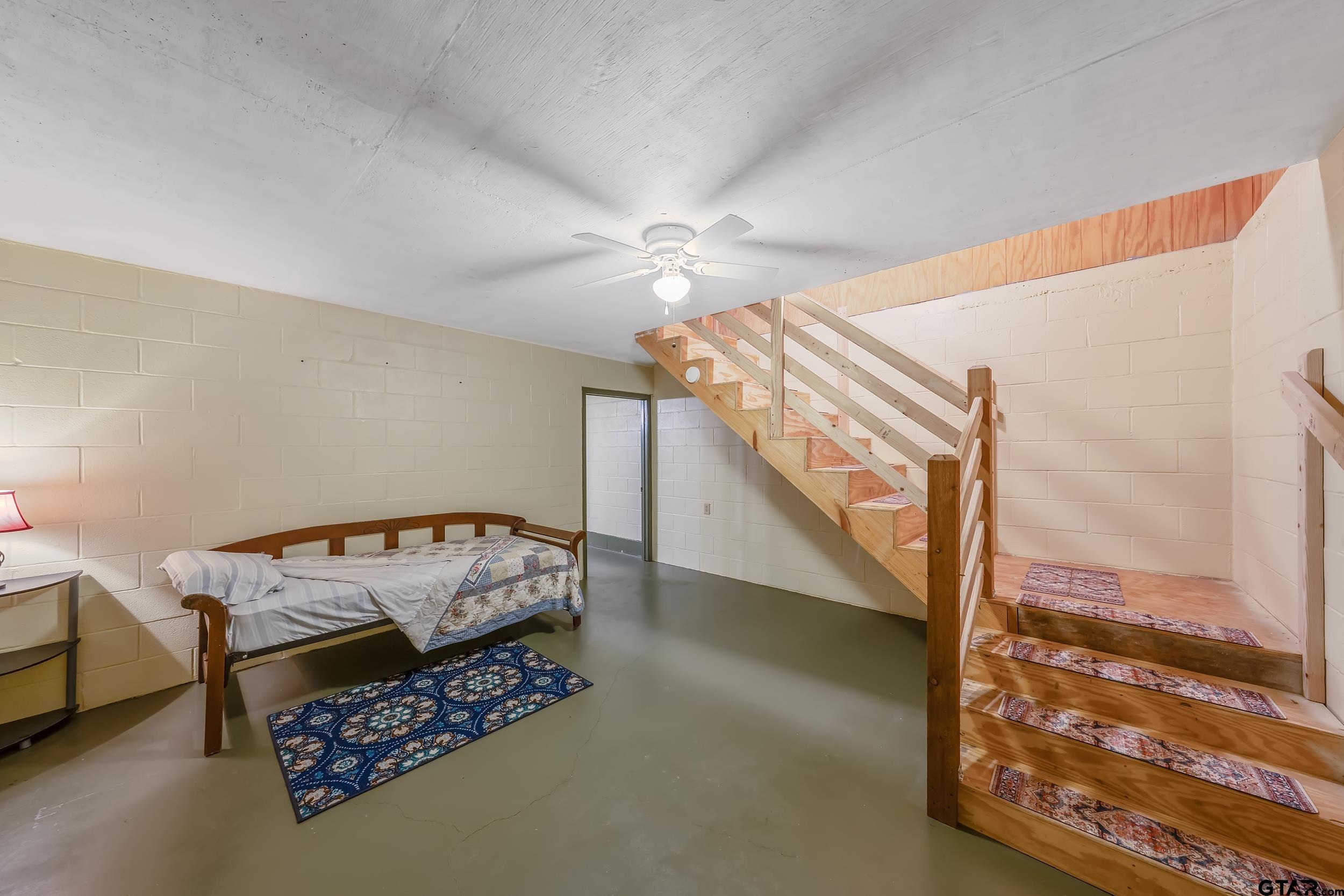 20304 State Highway 155 Winona, TX 75792 - Photo 32 of 48 a bedroom with furniture and a chandelier