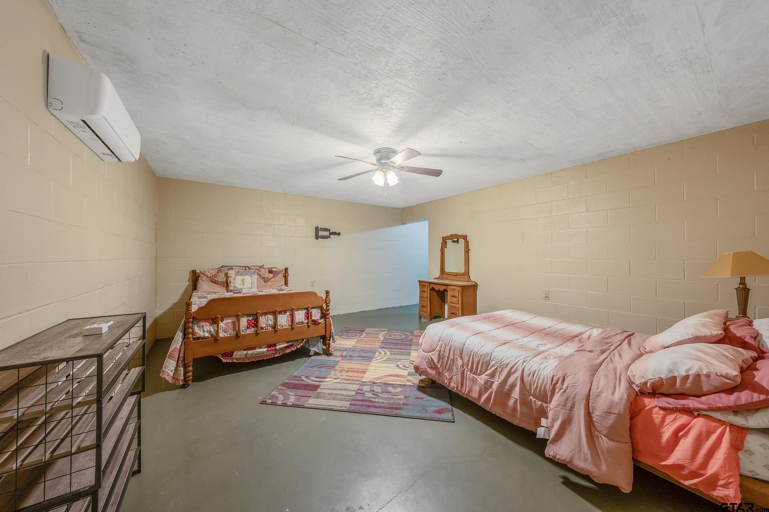 20304 State Highway 155 Winona, TX 75792 - Photo 33 of 48 a bedroom with a bed and a chandelier