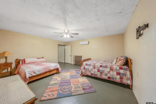 a spacious bedroom with a bed and a chandelier