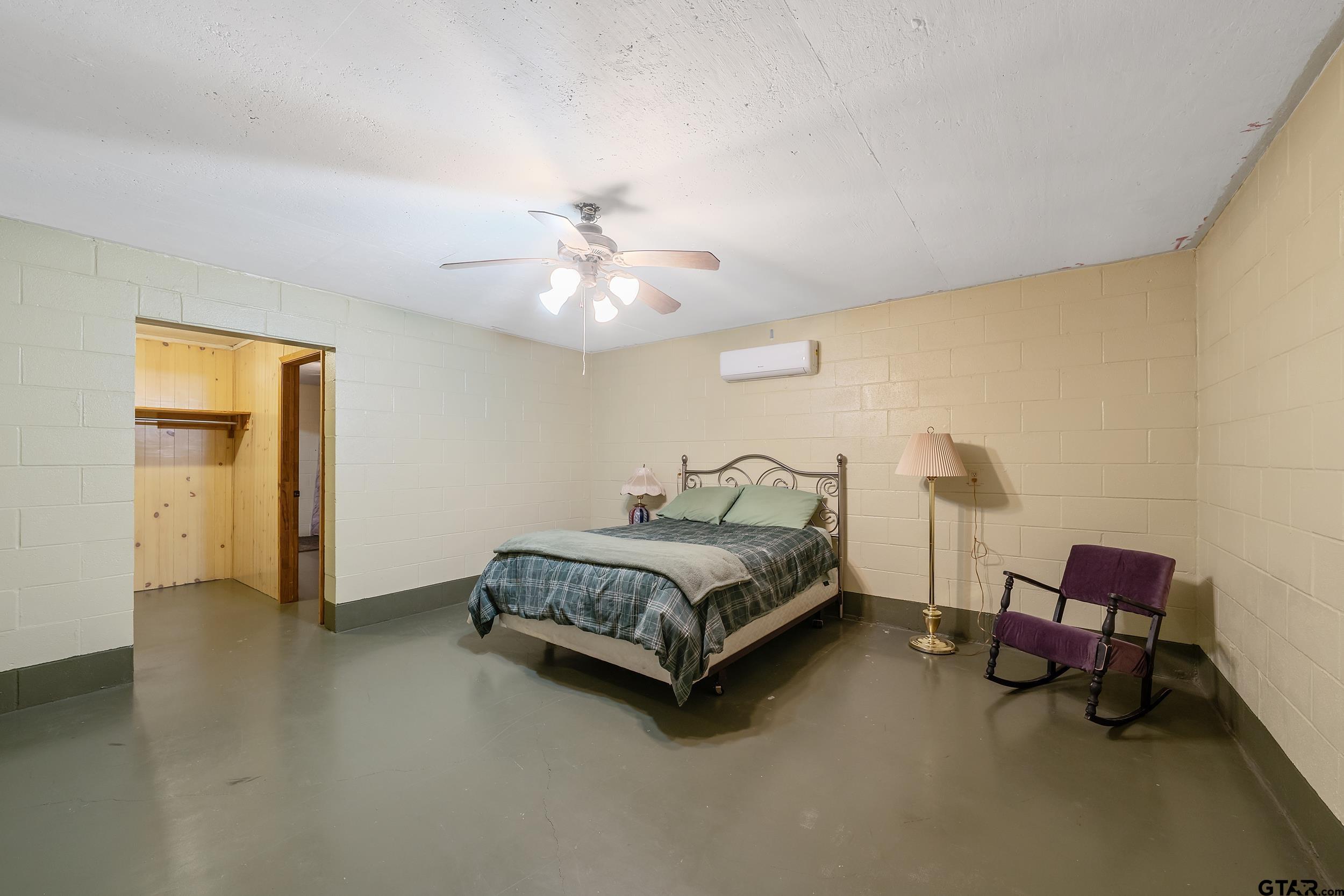 20304 State Highway 155 Winona, TX 75792 - Photo 36 of 48 a spacious bedroom with a bed and a chandelier