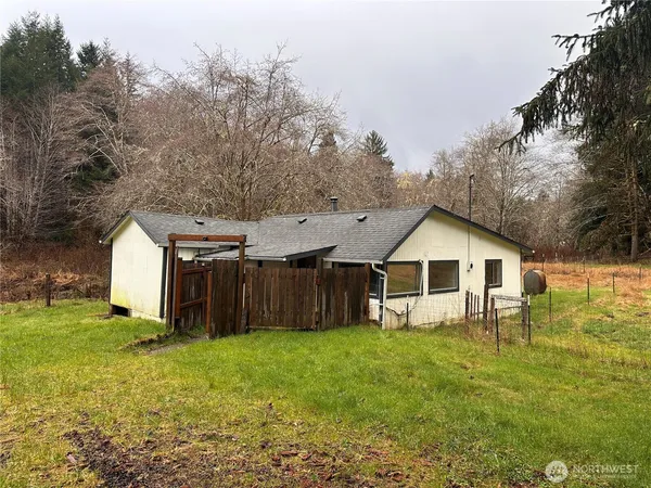 a view of a house with a yard and sitting area