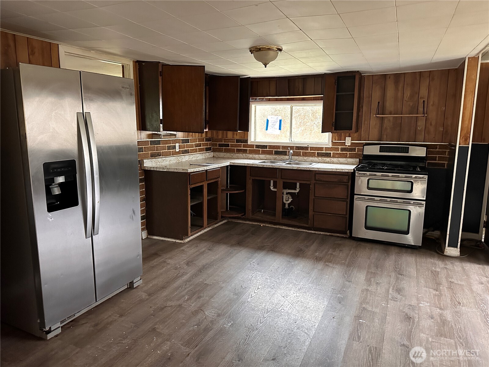 310 Butte Creek Road Raymond, WA 98577 - Photo 15 of 25 a kitchen with stainless steel appliances granite countertop a refrigerator a sink a stove a microwave and island