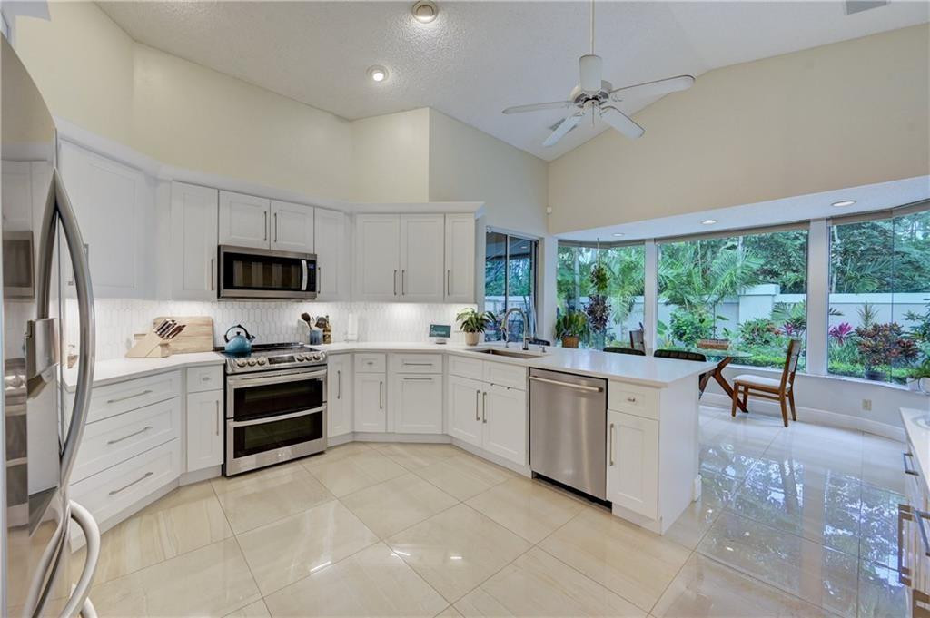 8171 Hampton Wood Drive Boca Raton, FL 33433 - Photo 53 of 56 a kitchen with granite countertop appliances cabinets and a sink