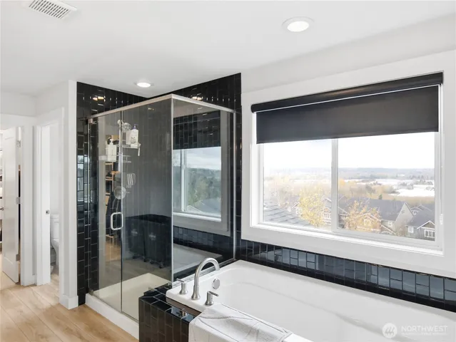 a bathroom with a bathtub and a large window