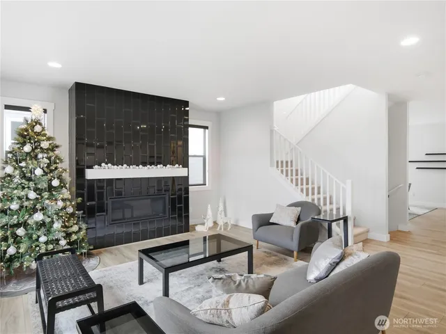 a living room with furniture a fireplace and a potted plant