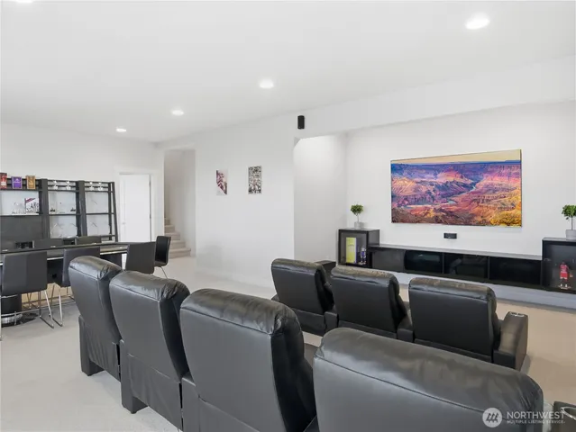 a media room with furniture a rug and a projector