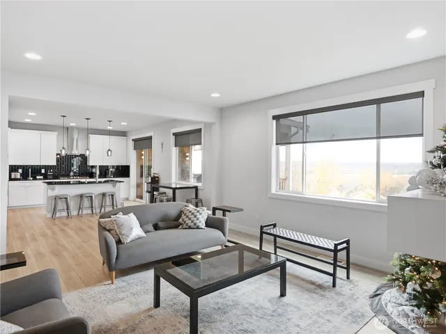 a living room with furniture and a large window